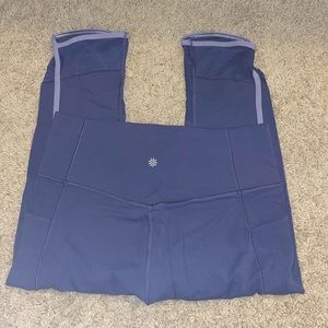 Size Large Navy Athleta Salutation Stash Pocket II Capri with lavender trim.